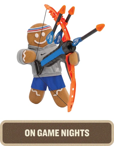 Gingerbread character dressed in athletic apparel holding a toy bow and arrow set. Text below reads “On Game Nights.”