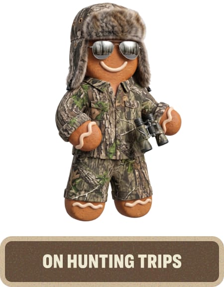 Gingerbread character wearing camouflage hunting gear, aviator sunglasses, and a fur-lined hat. Text below reads “On Hunting Trips.”