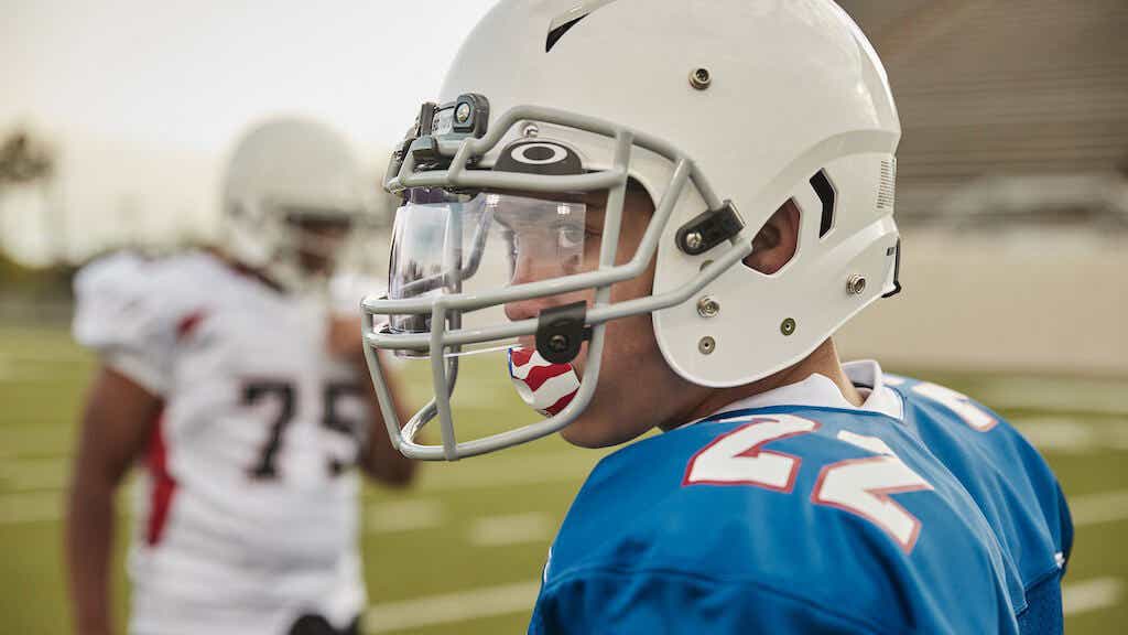 Kid wearing football protective equipment