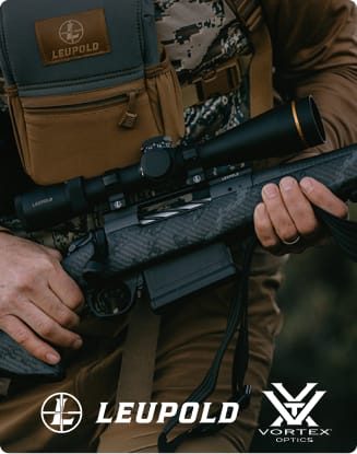 Close-up of a hunter carrying a rifle with a mounted Leupold scope and a chest-worn optics pouch.