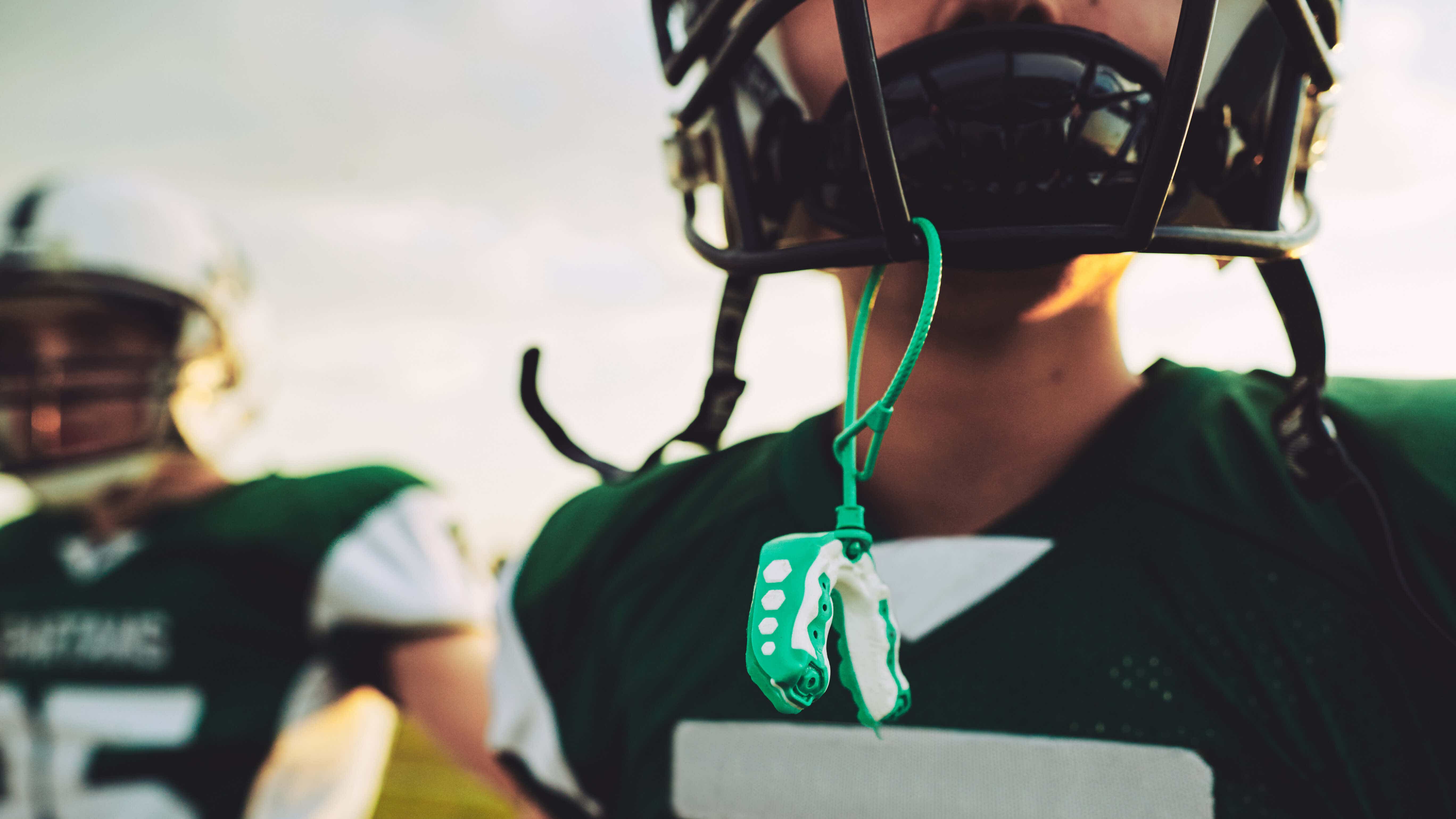 Football player using protective mouth guards