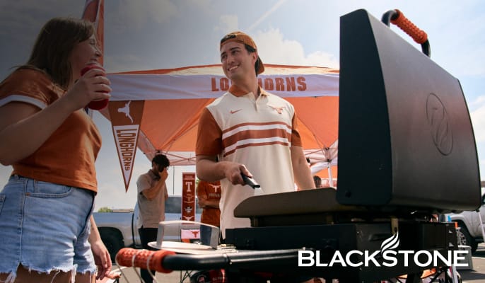 Blackstone 22-inch two-burner griddle at a tailgating event.