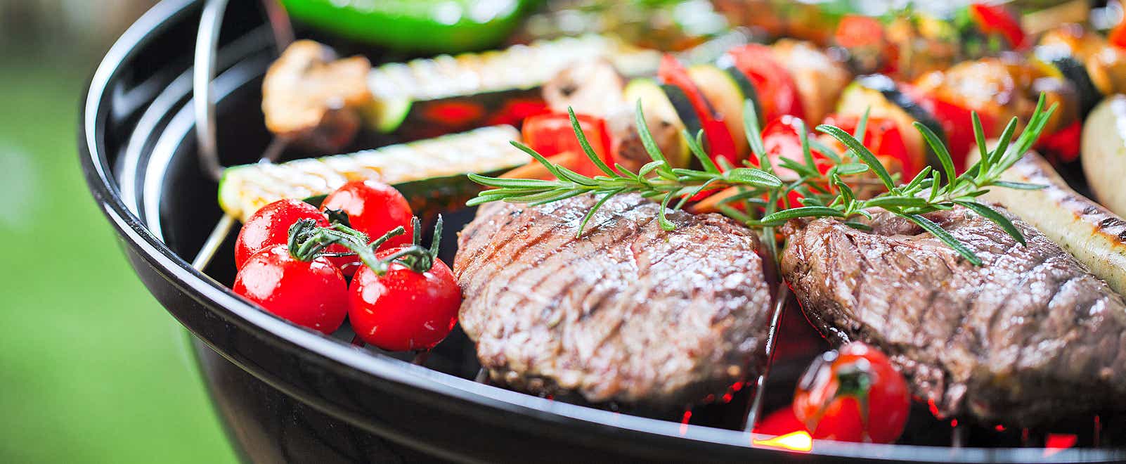 Beef and veggies searing over the barbecue pit fire