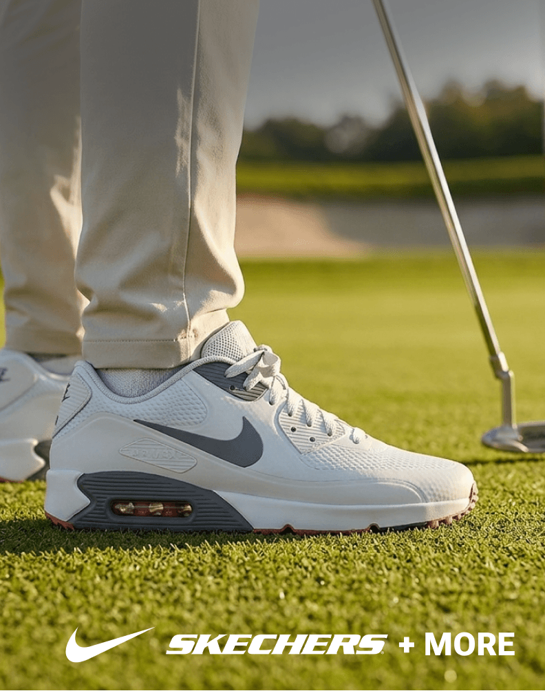 Golfer wearing a white Nike golf shoe while putting on a green.