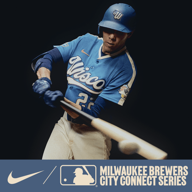 Professional baseball player wearing a light blue Milwaukee Brewers City Connect jersey and cap, holding a bat in dramatic studio lighting.