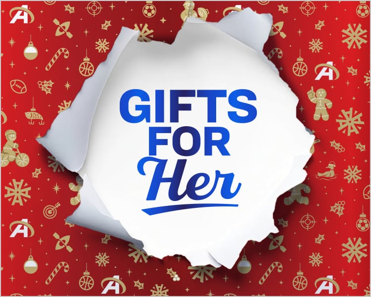 ‘Gifts for Her’ text inside a torn-paper opening on festive red holiday wrapping paper.”