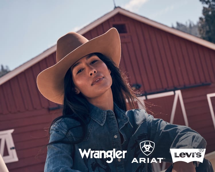 Person wearing a denim shirt and cowboy hat standing in front of a red barn. Wrangler, Ariat, and Levi’s logos appear along the bottom of the image.