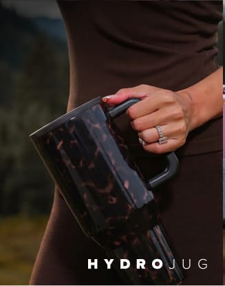 Assortment of insulated drinkware held by a person. HYDROJUG logo appears at the bottom of the image.
