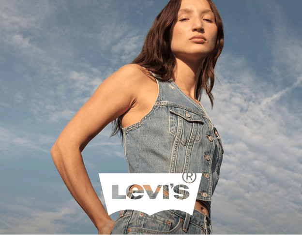 Girl wearing Levi’s denim outfit posing outdoors.
