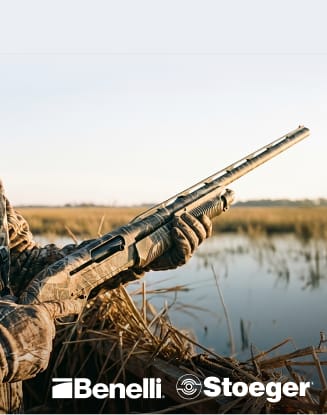 Hunter holding a shotgun in a marsh setting. Benelli and Stoeger logos displayed.