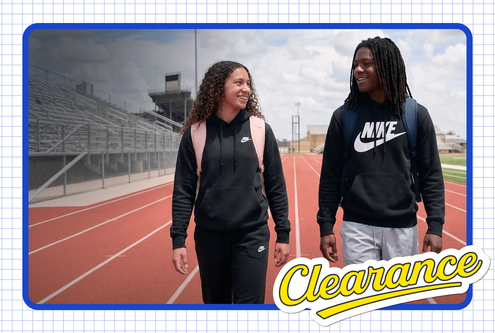 Two teenagers in Nike hoodies and backpacks walking on a school running track, featuring a Clearance promotional badge.