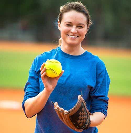 Woman with softball glove and ball