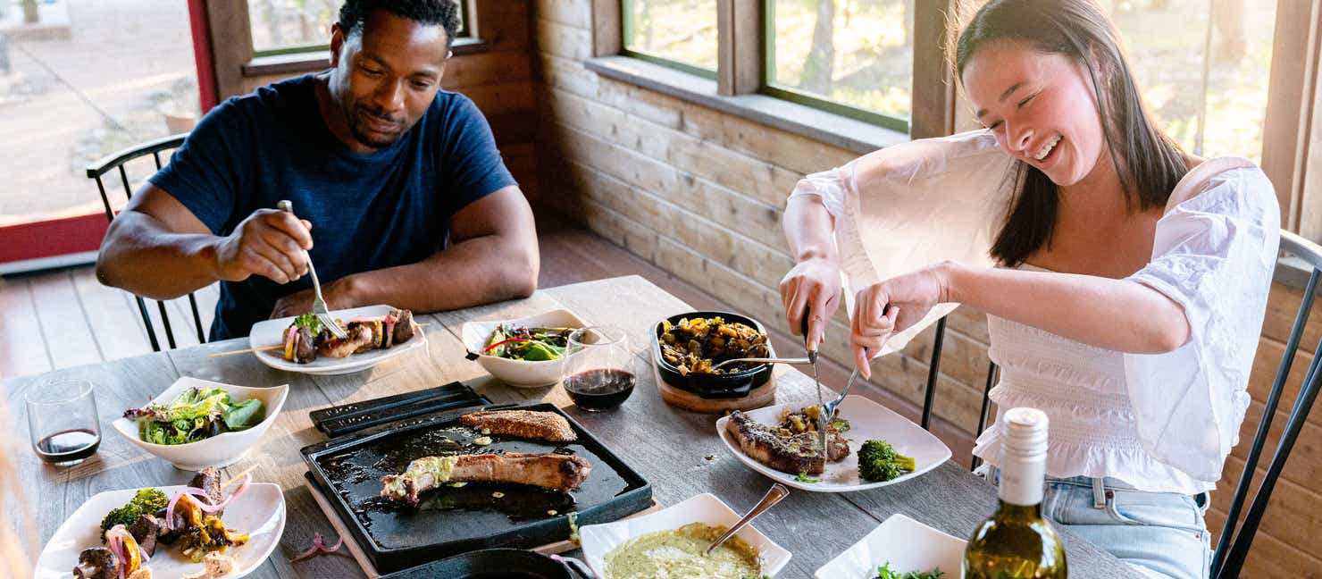 Couple enjoying a steak dinner made from an Ooni Pizza Oven