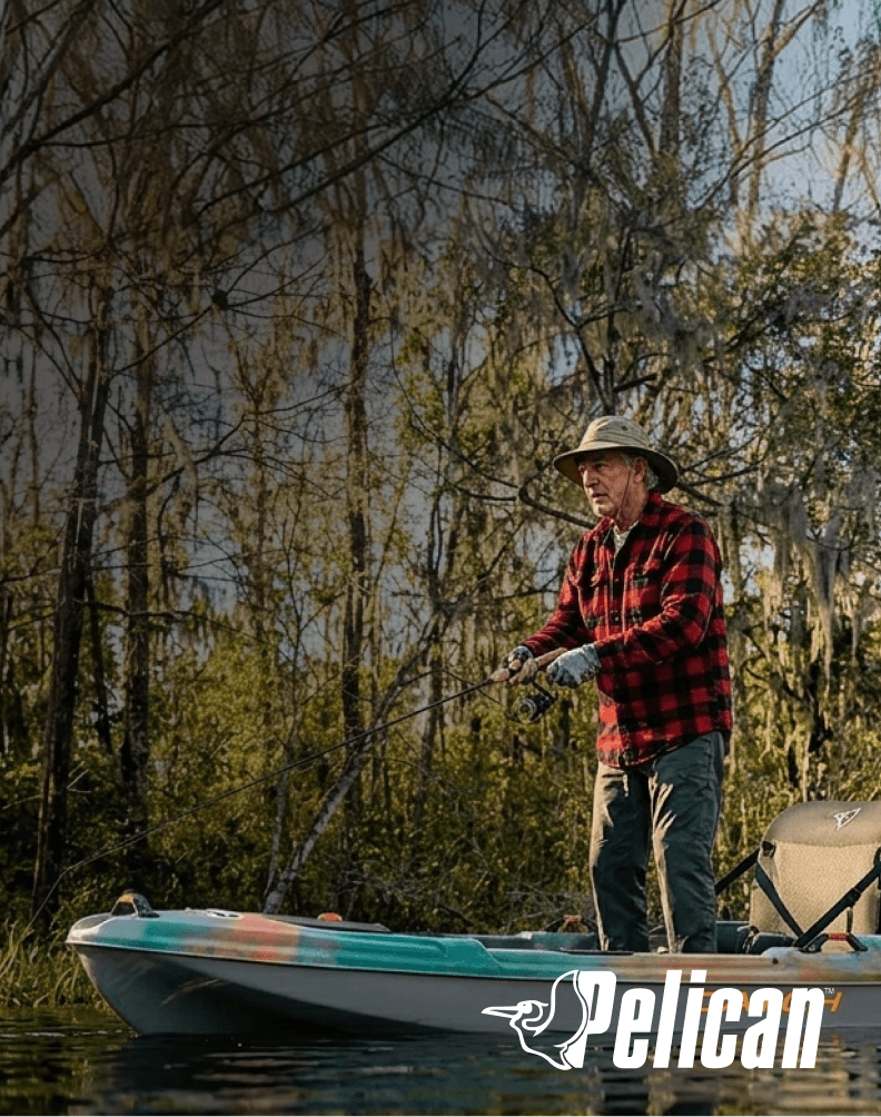 Angler fishing from a Pelican Catch Classic 100 kayak on a lake.