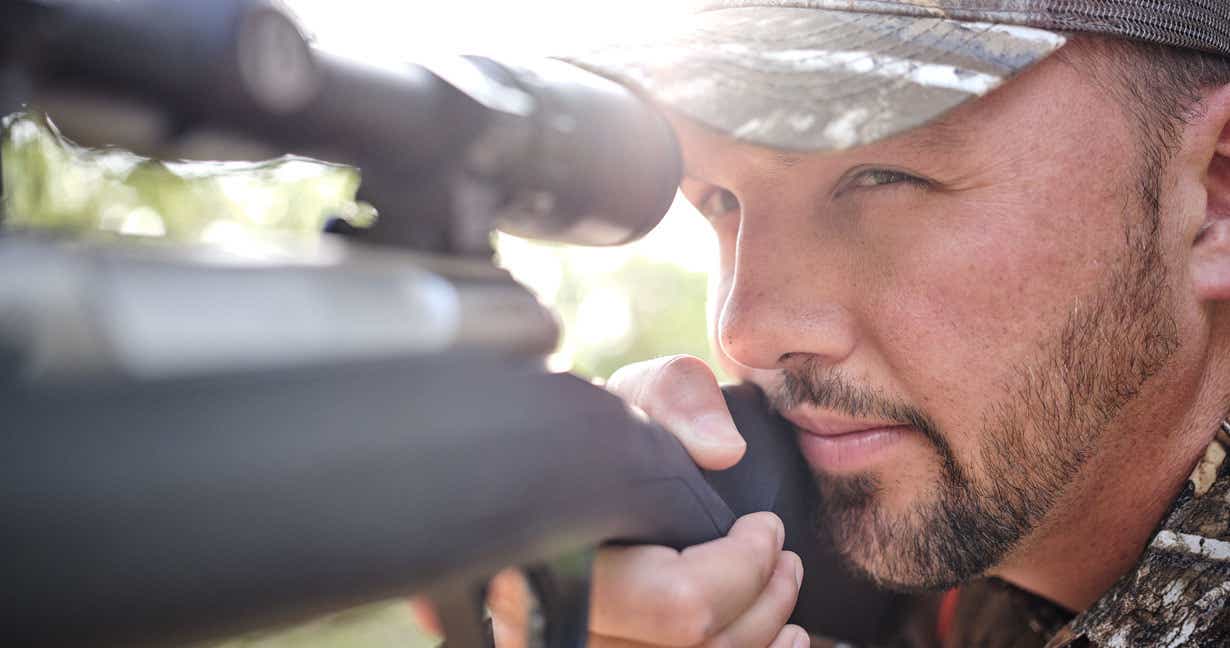 Man preparing to shoot a target from his rifle