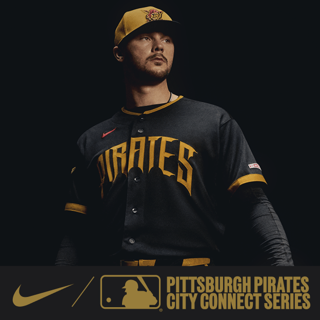 Professional baseball player wearing a black Pittsburgh Pirates City Connect jersey and cap in dramatic studio lighting.