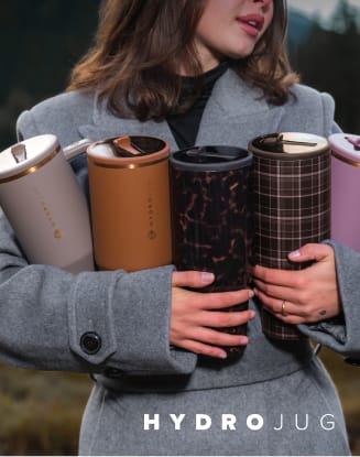 Assortment of insulated drinkware held by a person. HYDROJUG logo appears at the bottom of the image.