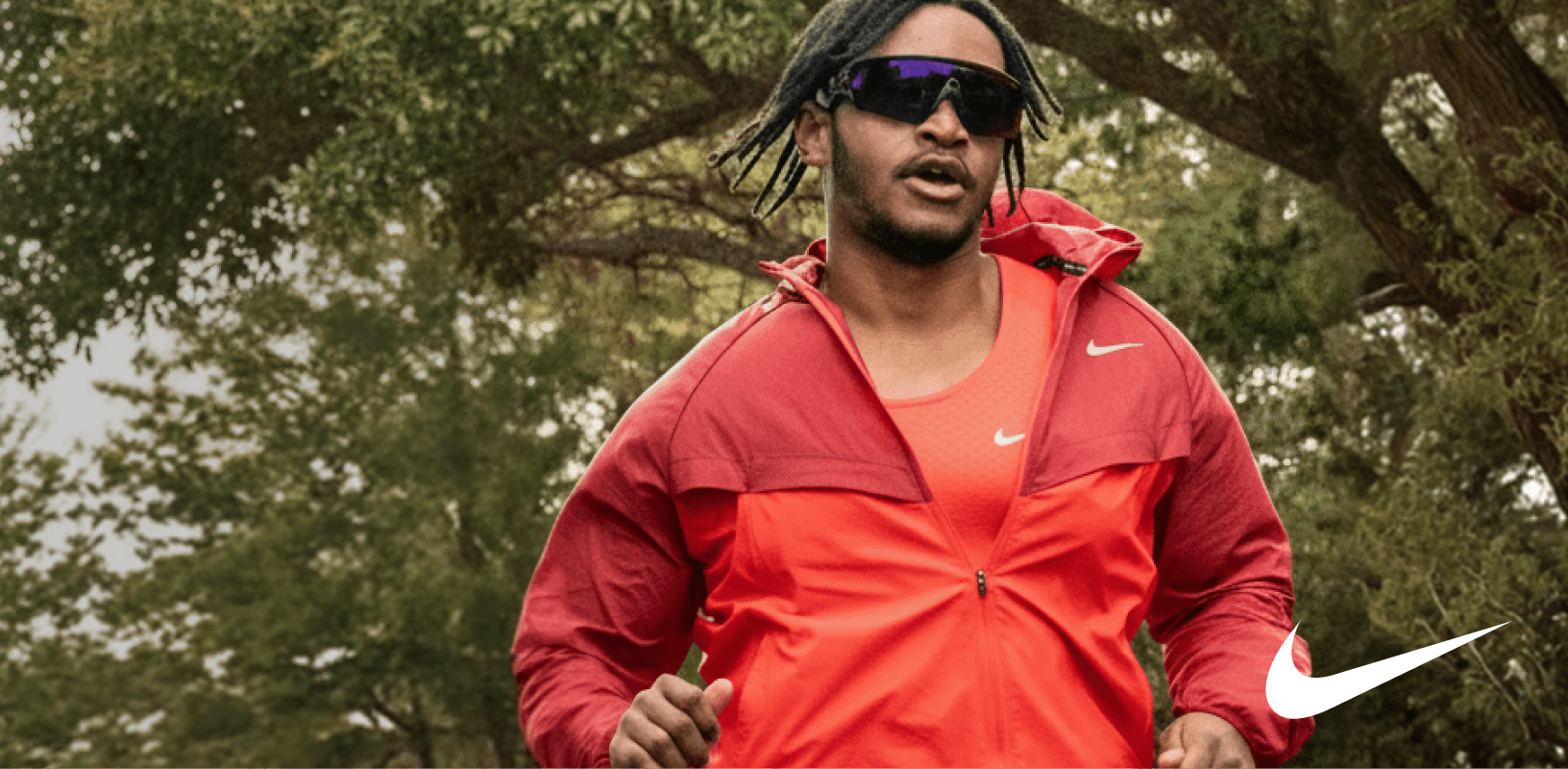Runner wearing red Nike running apparel outdoors.