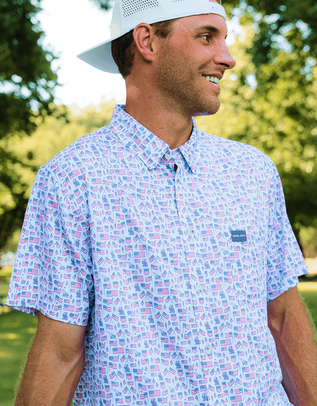 Person wearing a light blue patterned performance polo shirt outdoors in natural sunlight.