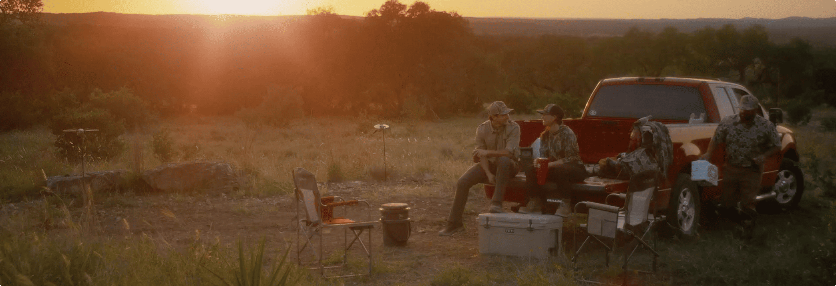 Customers gathered outdoors with an Academy truck at dusk