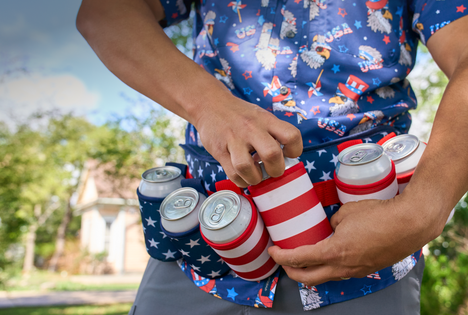 Close-up of a person wearing a patriotic eagle shirt and a can-holder belt filled with red, white and blue drink koozies.