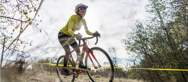 Woman navigates around a curve in a cyclocross race