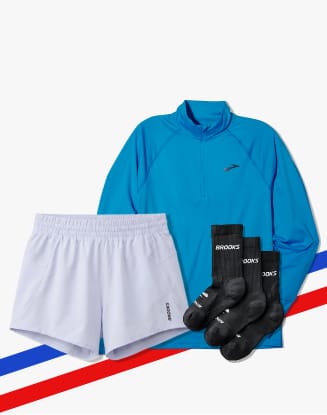 Blue Brooks quarter-zip top, white shorts, and black socks.