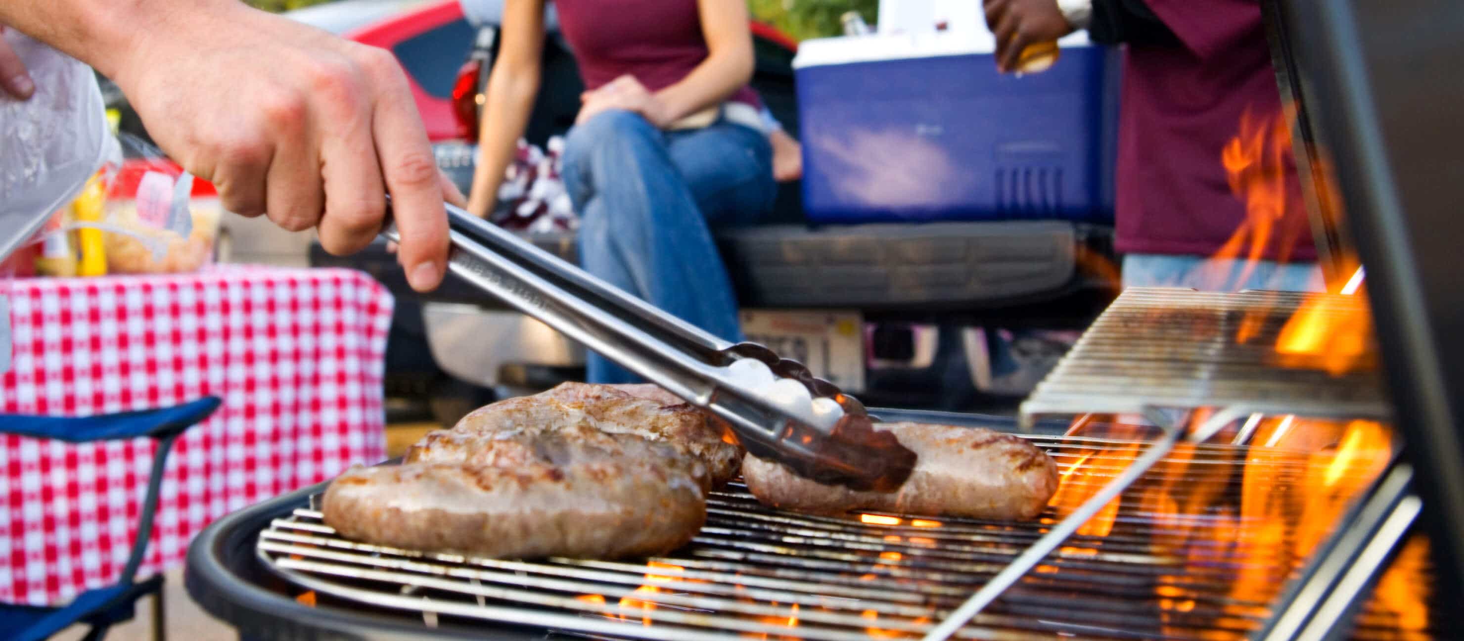 Tailgating checklist: Sausage On The Grill At Tailgate Party

                            