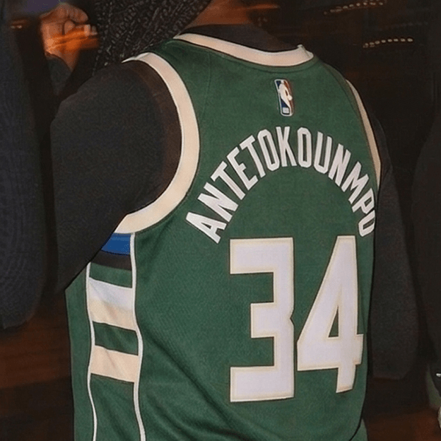 Back view of a green NBA basketball jersey with white trim showing the name ANTETOKOUNMPO and the number 34.
