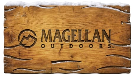 Magellan Outdoors logo carved into a weathered wooden surface topped with snow.