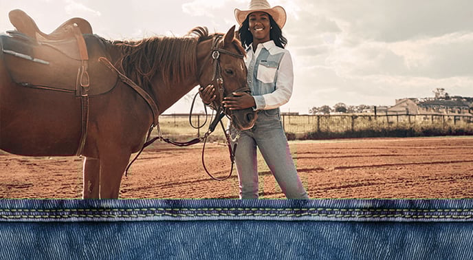 Woman wearing a western-style shirt and matching western skirt in a desert landscape.