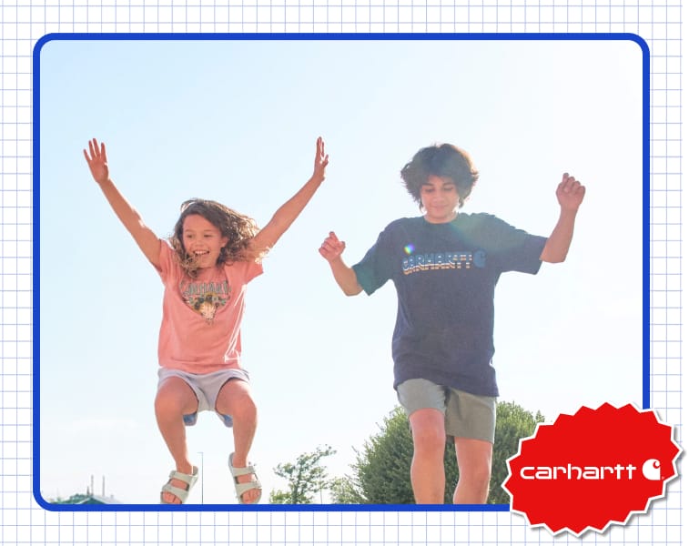 Children wearing Carhartt graphic T-shirts outdoors.