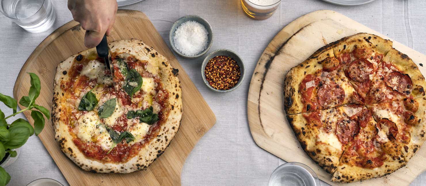Freshly cooked pizzas being served