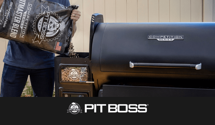 Pit Boss wood pellets being poured into the hopper of a Pit Boss Competition Series pellet grill outdoors.