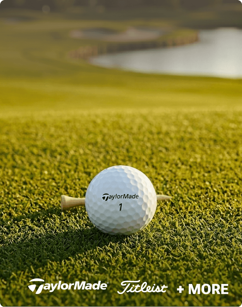 White golf ball on green grass representing TaylorMade and Titleist golf equipment.