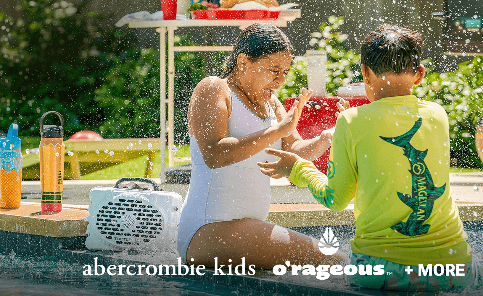 BOGO 50% off select family swimwear promotion showing people playing under water spray outdoors, with brand logos Abercrombie Kids and Orageous and text “+ More.