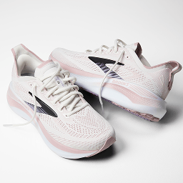 Pair of white Brooks Adrenaline GTS 26 running shoes with black and soft pink accents shown from multiple angles on a white background.