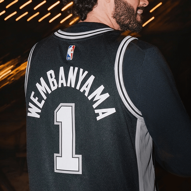 Back view of a black NBA basketball jersey showing the name WEMBANYAMA and the number 1.