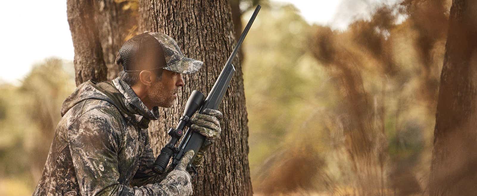 A hunter in the woods with his rifle