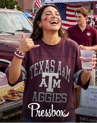 Person wearing a Texas A&M shirt at a tailgate gathering. Pressbox branding displayed.