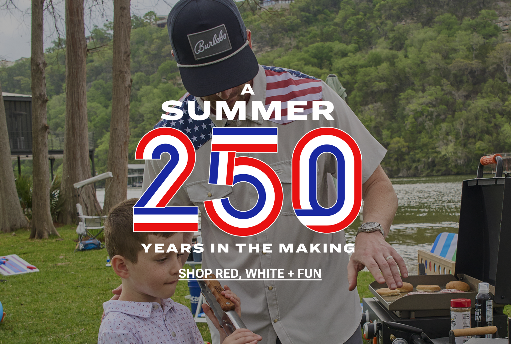 A Summer 250 Years in the Making. A dad and his son grill burgers and hot dogs at a lakeside Fourth of July cookout. Shop red, white and fun.