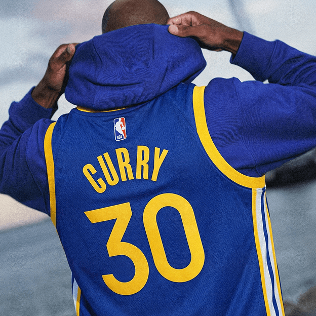 Back view of a blue NBA basketball jersey with yellow trim showing the name CURRY and the number 30.