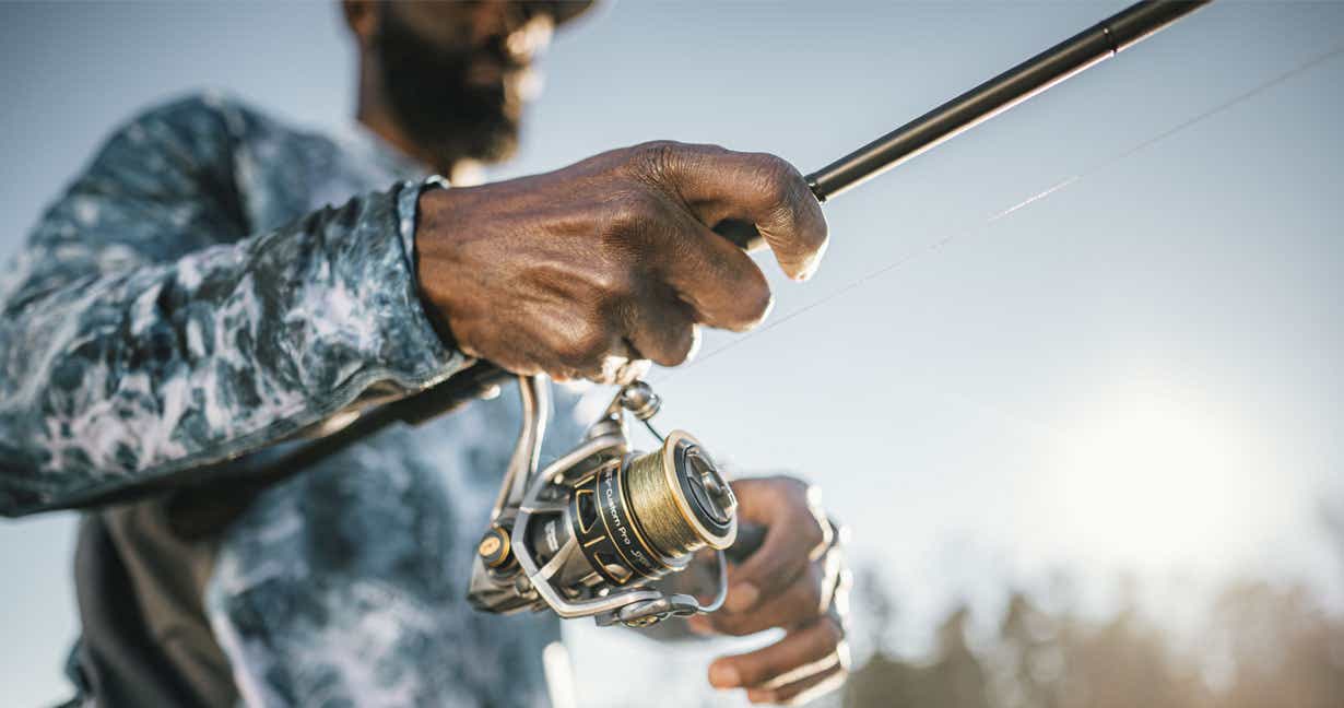 Man reeling in a catch on his fishing reel