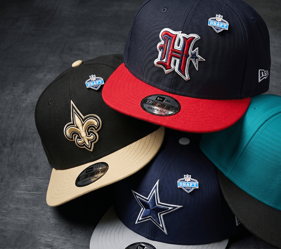 NFL Draft Hats displayed on a flat brim with team logos