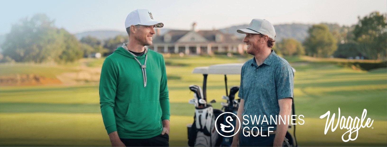 Two golfers standing on a golf course wearing Swannies Golf and Wrangle apparel with golf bags in the background.