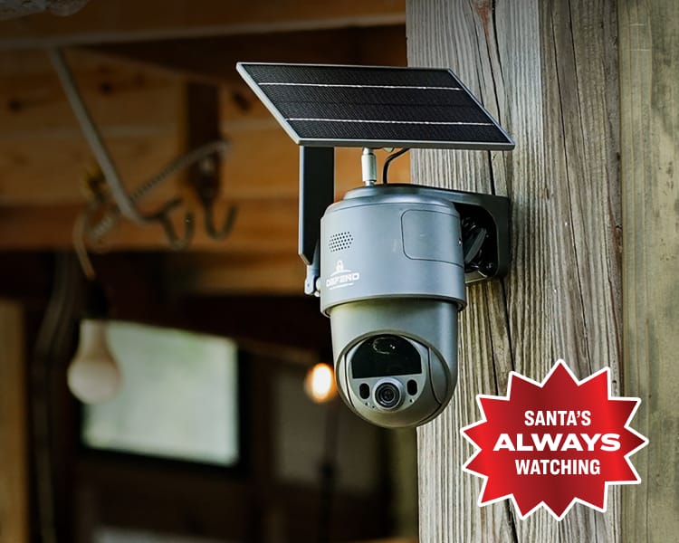 Tactacam Defend 360 cellular security camera mounted under a wooden structure. Overlay red badge reads “Santa’s Always Watching.”