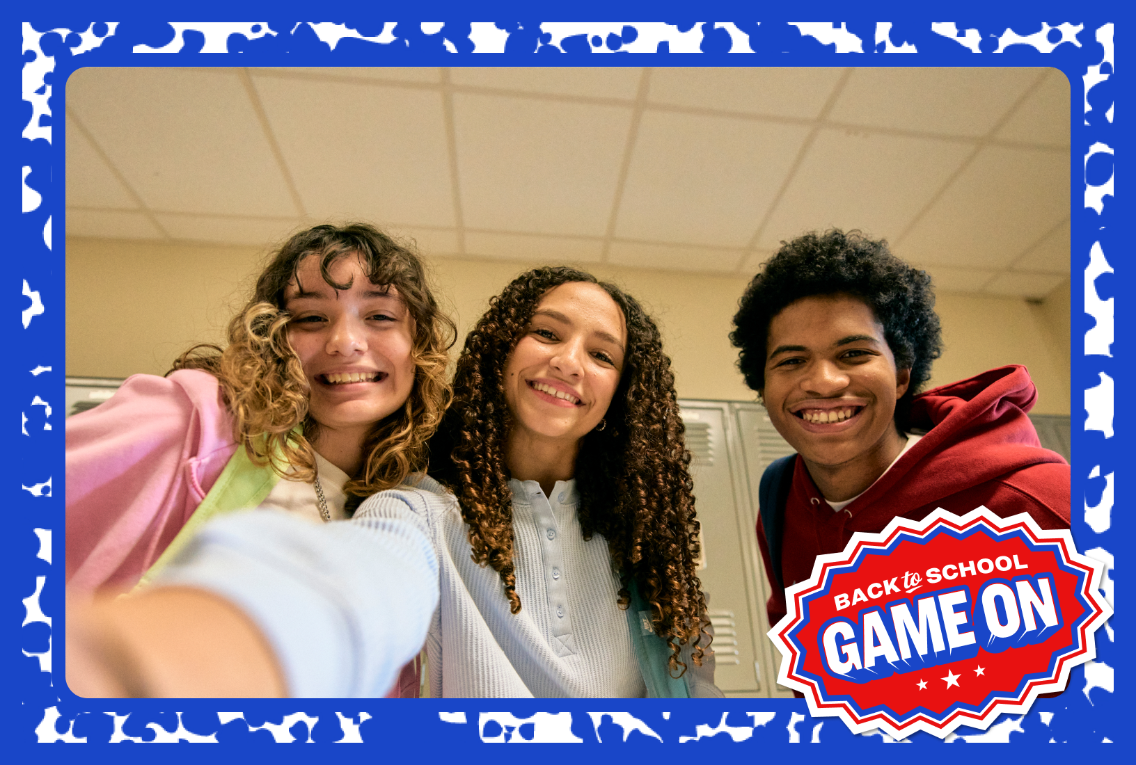 Three students taking a selfie in a classroom with a Back-to-School Game On badge overlaid.