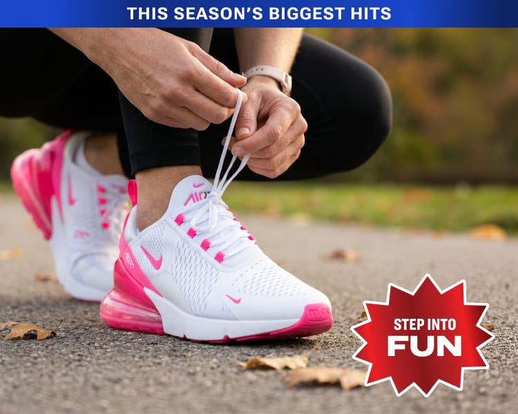 White and pink Nike Air Max 270 athletic shoe shown outdoors with overlaid badge 'Step Into Fun.'