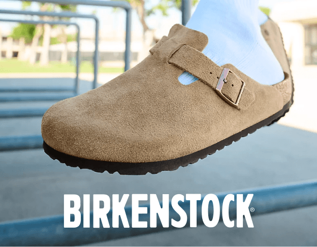 Close-up of a tan Birkenstock clog on a light background.