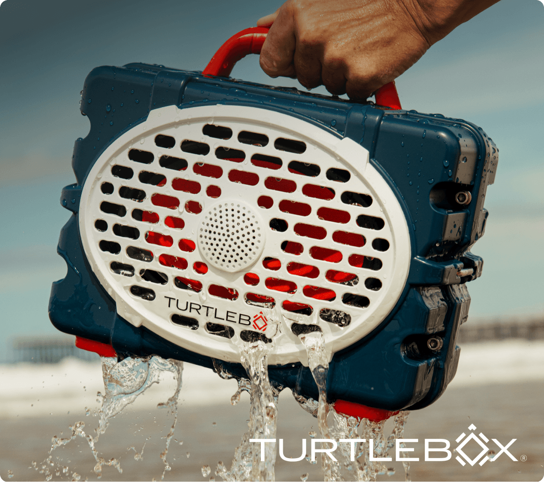 Turtlebox speaker in Americana blue with patriotic decorations in the background.